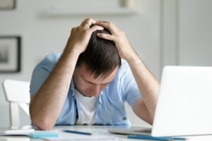 Empresario agotado frente al laptop
